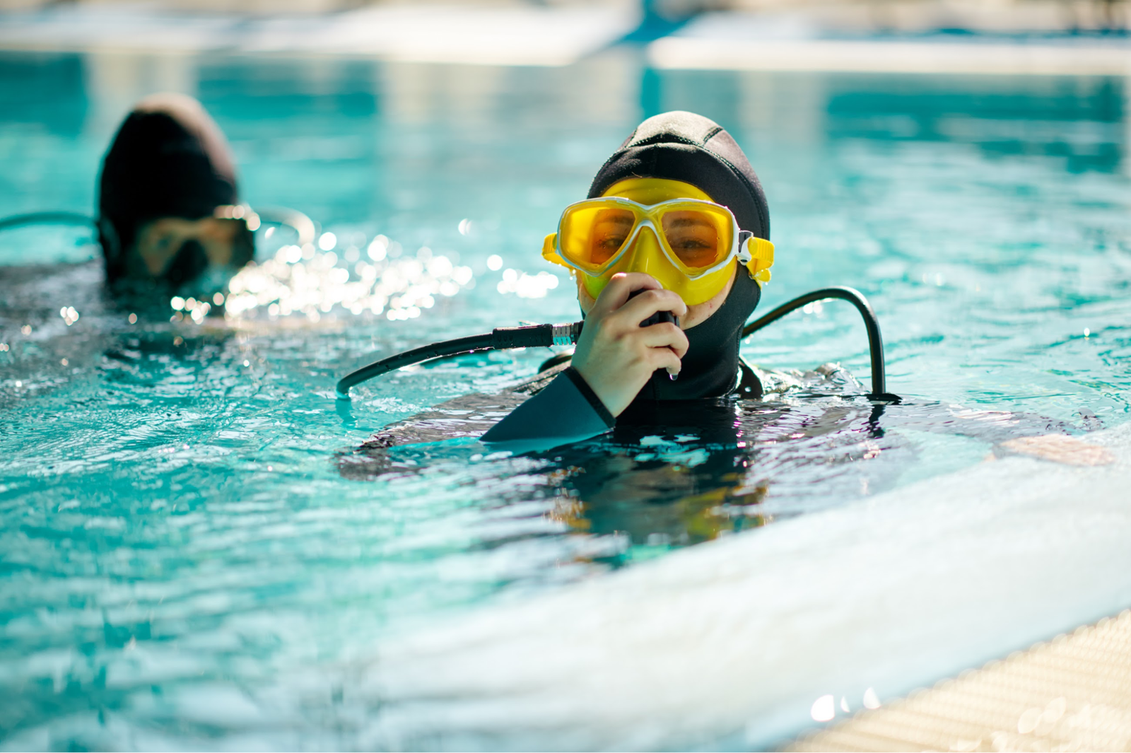 A man preparing to dive indoors.