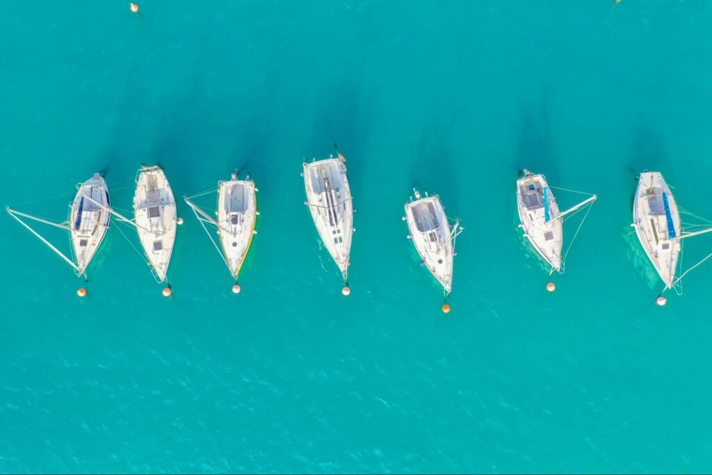 An aerial view of sail boats in the ocean