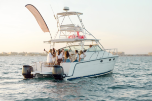 A group of young people having a good time on a boat in the water.